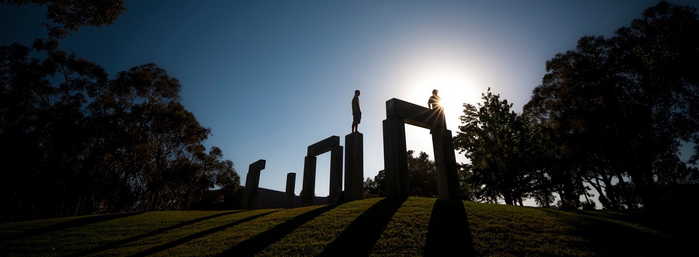 photo of people standing on the stone henge sculpture at Revelle
