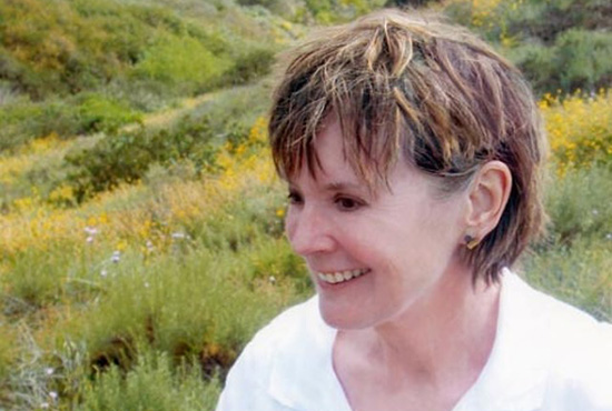 Photo of Susan Smith smiling in a field of flowers