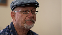 Thumbnail photo of a man, link to poster