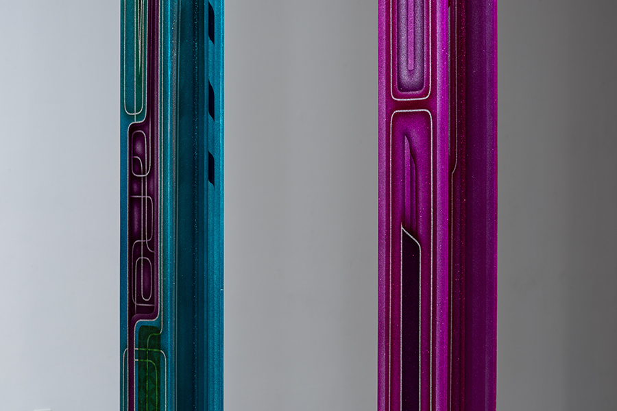 photo of sculpture, vertical decorated blue bar beside decorated pink bar