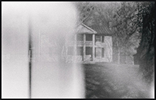 black and white photo of an obsured house