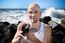 photo of Adam Kamil holding a video camera