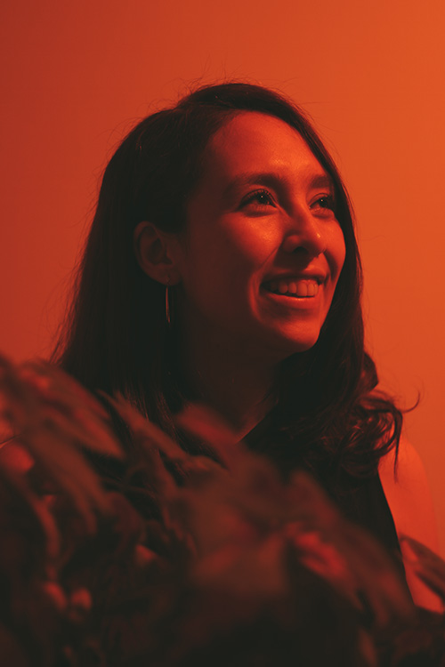 photo of Doreen smiling in orange light